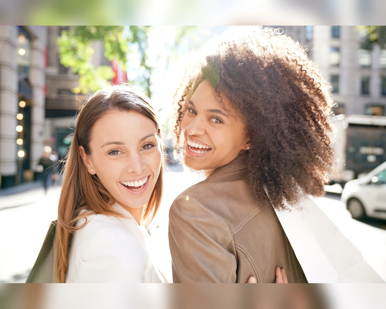 Smiling friends outdoors in warm light